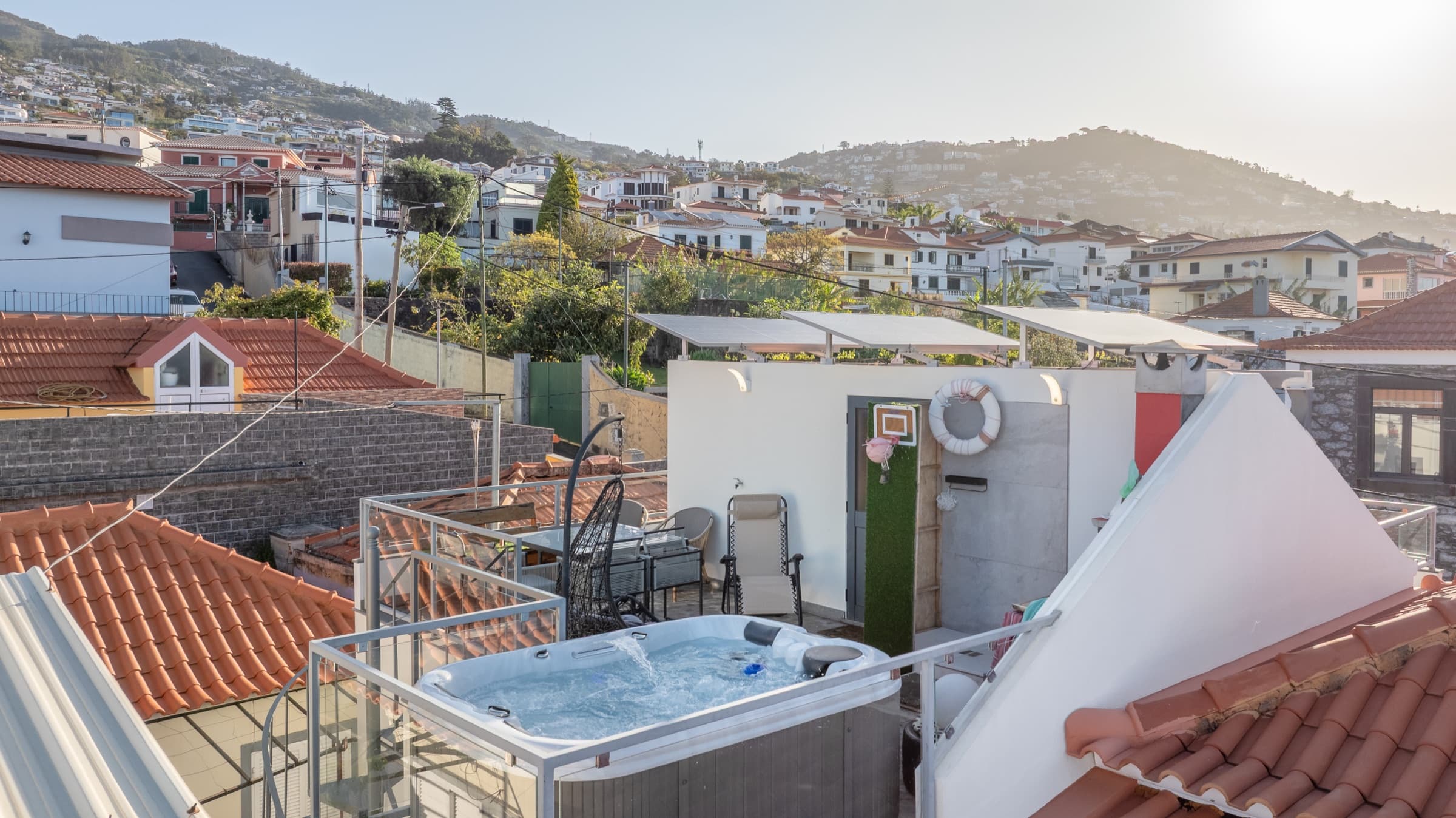 Aerial view of the terrace and jacuzzi with the Funchal hills behind