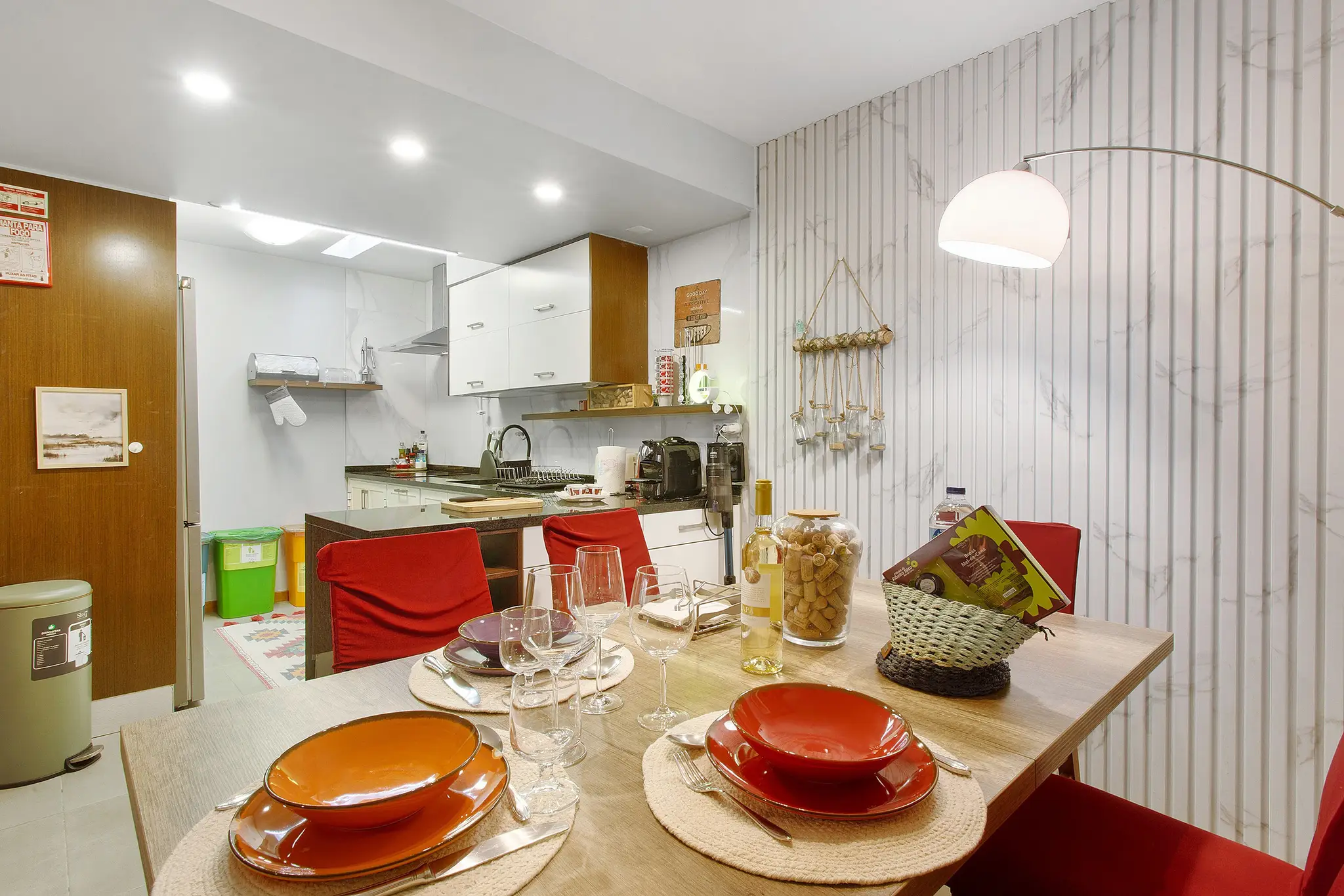 Living and dining area with red sofa and open-plan kitchen