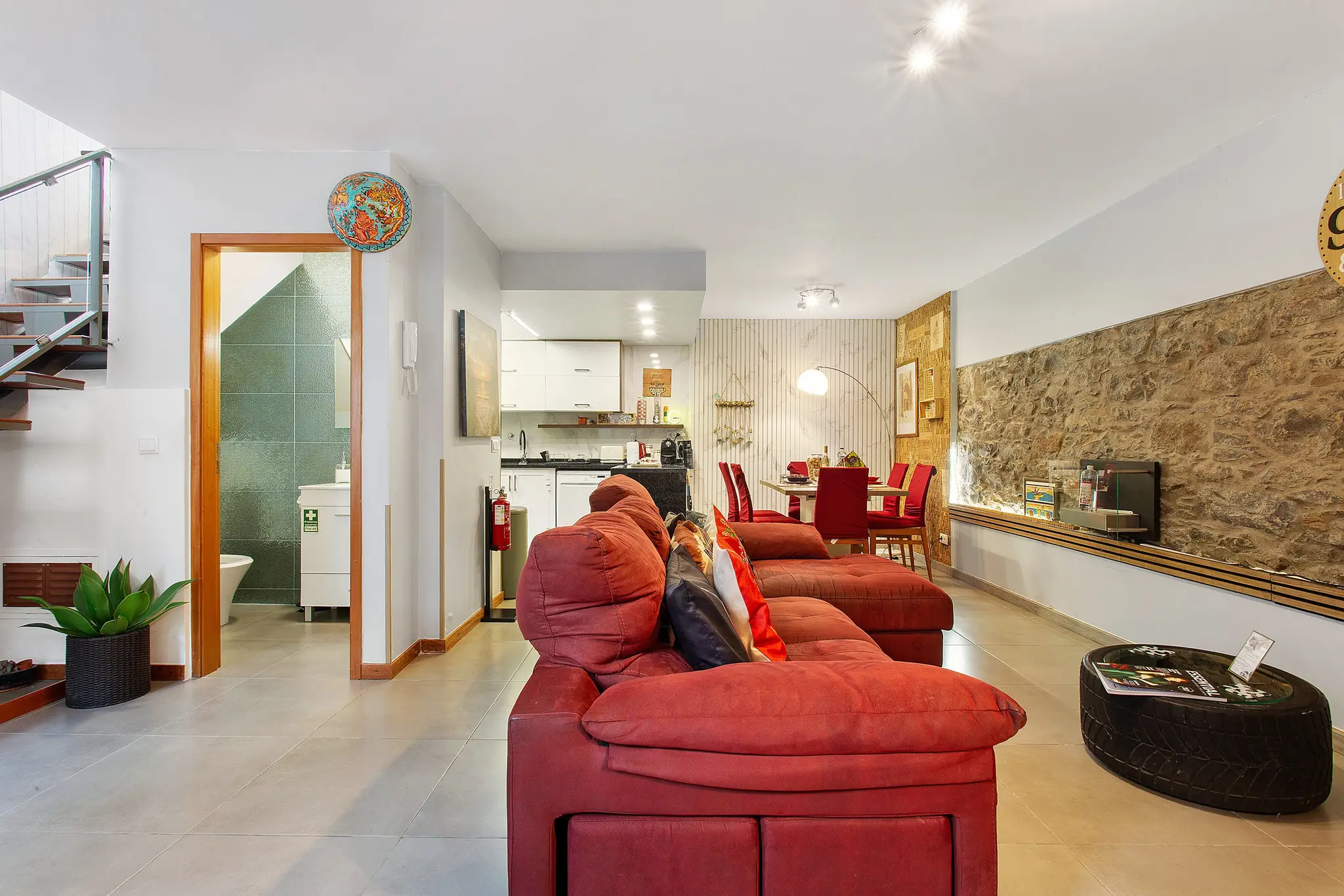 Spacious lounge with stone feature wall, dining table and open kitchen